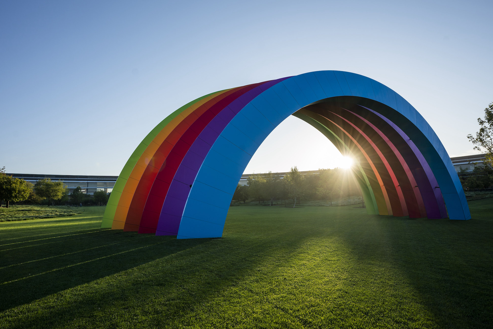 The Rainbow sculpture at Apple Park, a large semi-circular structure spanning the inner ring lawn
